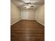 Bedroom featuring ceiling fan, generous closet space, and wainscoting at 143 Tracy Ln, Mcdonough, GA 30253