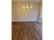 An elegant chandelier hangs over the dining room with nice wood flooring at 143 Tracy Ln, Mcdonough, GA 30253