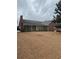 Brick home exterior showcasing an enclosed porch and expansive backyard space at 143 Tracy Ln, Mcdonough, GA 30253