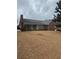 Brick home exterior showcasing an enclosed porch and expansive backyard space at 143 Tracy Ln, Mcdonough, GA 30253
