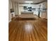 Bright kitchen featuring white cabinetry, hardwood floors, and a center island, perfect for cooking at 143 Tracy Ln, Mcdonough, GA 30253