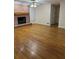 A warm, inviting living room features a fireplace, wood floors, and ample natural light at 143 Tracy Ln, Mcdonough, GA 30253