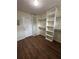 Spacious walk-in closet with wood-style flooring and custom shelving for optimal storage solutions at 143 Tracy Ln, Mcdonough, GA 30253