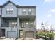 Two-story townhome with modern gray and blue siding, attached garage, and balcony at 200 Chestnut Cir, Atlanta, GA 30342