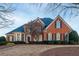 Brick home with a large front yard and mature trees at 1850 Briergate Dr, Duluth, GA 30097