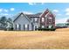 Two-story house with gray and brick siding, and a well-manicured lawn at 3805 Dogwood Farm Rd, Decatur, GA 30034