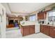 Kitchen with dark wood cabinets, a breakfast bar, and a view of living room at 3805 Dogwood Farm Rd, Decatur, GA 30034