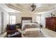 Spacious main bedroom with tray ceiling, ceiling fan, and large dresser at 3805 Dogwood Farm Rd, Decatur, GA 30034