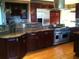 Gourmet kitchen with granite countertops and cherry wood cabinetry at 730 Orchard Pt, Atlanta, GA 30350