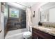 Updated bathroom with a granite countertop, tile shower, and a bathtub at 930 White St, Atlanta, GA 30310