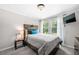 Bedroom with a queen bed, wooden headboard, and backyard view at 930 White St, Atlanta, GA 30310
