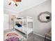 Bedroom with a bunk bed, colorful rug, and a ceiling fan at 930 White St, Atlanta, GA 30310