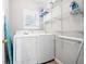 Laundry room with washer, dryer, and storage shelves at 930 White St, Atlanta, GA 30310