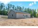 A rear view of the house showing the back and side with a view of the large backyard at 121 Hunters Ln, Powder Springs, GA 30127