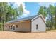 View of the home's exterior with gray siding and a large backyard at 121 Hunters Ln, Powder Springs, GA 30127