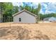 Home exterior featuring gray siding and a spacious backyard with newly installed grass at 121 Hunters Ln, Powder Springs, GA 30127