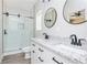 Bathroom featuring a dual sink vanity and walk-in tiled shower at 121 Hunters Ln, Powder Springs, GA 30127