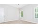 Bright, carpeted bedroom with two windows at 121 Hunters Ln, Powder Springs, GA 30127