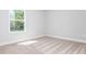 Bright bedroom with neutral carpet, white walls, and a window for natural light at 121 Hunters Ln, Powder Springs, GA 30127
