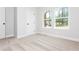 Bright bedroom with neutral carpet, white trim, and two windows at 121 Hunters Ln, Powder Springs, GA 30127