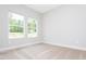 Minimalist bedroom featuring neutral carpet, white walls, and double windows for ample natural light at 121 Hunters Ln, Powder Springs, GA 30127