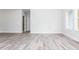 Bright, open-concept living room with modern gray vinyl flooring and neutral wall colors at 121 Hunters Ln, Powder Springs, GA 30127