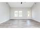 Bright and airy living room with large windows and modern gray wood-look flooring at 121 Hunters Ln, Powder Springs, GA 30127