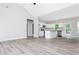Open-concept living area flowing into a kitchen with white cabinetry and stainless appliances at 121 Hunters Ln, Powder Springs, GA 30127