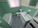 Bathroom with green tile, white sink, and tub at 2842 Delowe Dr, Atlanta, GA 30344