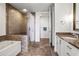 Modern bathroom with granite vanity, soaking tub, and glass shower at 270 17Th Nw St # 809, Atlanta, GA 30363