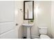 Small bathroom with pedestal sink, toilet, and framed mirror at 270 17Th Nw St # 809, Atlanta, GA 30363