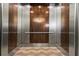Clean and modern elevator with wood and metal finishes at 270 17Th Nw St # 809, Atlanta, GA 30363