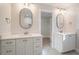 Double vanity bathroom with white cabinets and oval mirrors at 56 Veranda Walk, Dallas, GA 30157