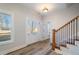 Bright and airy entryway with hardwood floors and a staircase with iron railings at 56 Veranda Walk, Dallas, GA 30157