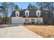 Two-story farmhouse with a white exterior, gray roof, and a large front porch at 56 Veranda Walk, Dallas, GA 30157