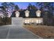 Two-story farmhouse with a white exterior, gray roof, and a large front porch at 56 Veranda Walk, Dallas, GA 30157
