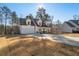 Two-story farmhouse with a white exterior, gray roof and a large front porch at 56 Veranda Walk, Dallas, GA 30157
