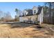Two-story farmhouse with a white exterior, gray roof and a large front porch at 56 Veranda Walk, Dallas, GA 30157