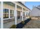 Charming front porch with white columns, stone accents, and a light blue ceiling at 56 Veranda Walk, Dallas, GA 30157