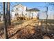 White two story house with deck and wooded backyard at 56 Veranda Walk, Dallas, GA 30157