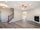 Spacious living room with hardwood floors, a fireplace, and a ceiling fan at 56 Veranda Walk, Dallas, GA 30157