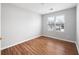Well-lit bedroom featuring wood-look floors and dual windows at 6977 Gallant Se Cir # 8, Mableton, GA 30126