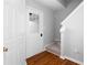 Bright entryway with wood-look floors, white door, and carpeted staircase at 6977 Gallant Se Cir # 8, Mableton, GA 30126