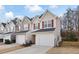 Tan siding townhouses with red shutters and attached garages at 6977 Gallant Se Cir # 8, Mableton, GA 30126