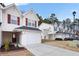 Townhouse with white siding, red shutters, and a two-car garage at 6977 Gallant Se Cir # 8, Mableton, GA 30126
