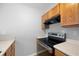 Kitchen boasts stainless steel range, wood cabinets, and neutral countertops at 6977 Gallant Se Cir # 8, Mableton, GA 30126