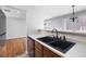 Modern kitchen with a black double sink and wood cabinets at 6977 Gallant Se Cir # 8, Mableton, GA 30126