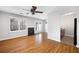 Open living room and kitchen with hardwood floors, fireplace and ceiling fan at 6977 Gallant Se Cir # 8, Mableton, GA 30126