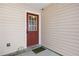 Red door entry to a townhouse unit with landscaping at 6977 Gallant Se Cir # 8, Mableton, GA 30126