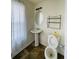 Bathroom with pedestal sink, toilet, and window at 1188 To Lani Path, Stone Mountain, GA 30083